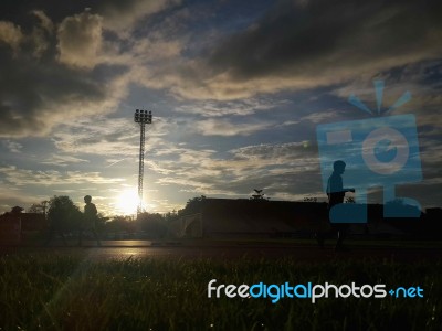 Silhouette  Running On Road At Sunrise Stock Photo