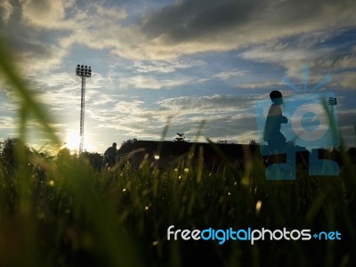 Silhouette  Running On Road At Sunrise Stock Photo