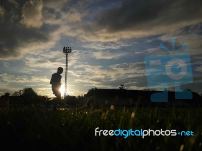 Silhouette  Running On Road At Sunrise Stock Photo