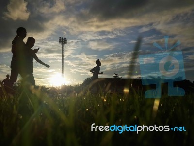 Silhouette  Running On Road At Sunrise Stock Photo