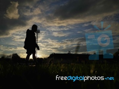 Silhouette  Running On Road At Sunrise Stock Photo