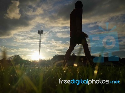 Silhouette  Running On Road At Sunrise Stock Photo