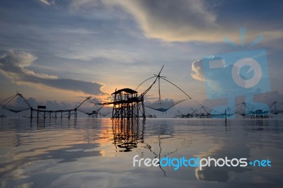 Silhouette Traditional Fishing Method Using A Bamboo Square Dip Stock Photo