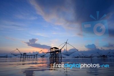 Silhouette Traditional Fishing Method Using A Bamboo Square Dip Stock Photo