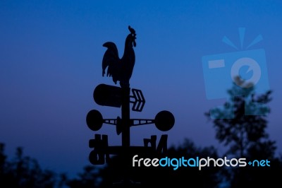 Silhouette Wheather Vane At Dawn Stock Photo