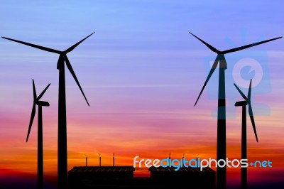 Silhouette Wind Turbine Generator With Factory Emissions Of Carb… Stock Photo