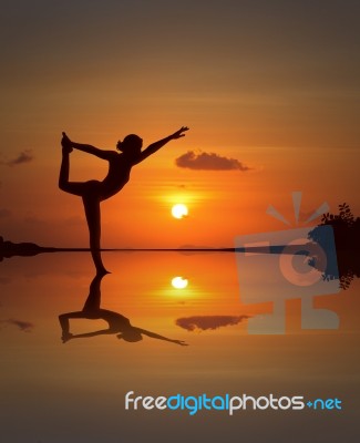 Silhouette Woman Doing Yoga Stock Photo