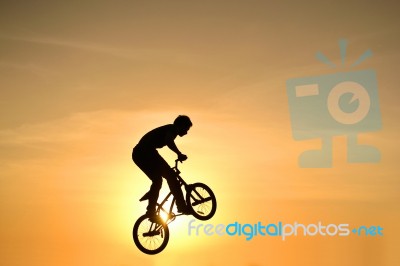 Silhouetted Bicycle Rider Stock Photo