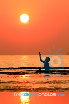 Silhouetted Woman On Beach  Stock Photo