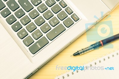 Silver Laptop And Notebook And Pen On Wood Table Vintage Style Stock Photo