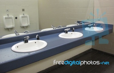 Sinks And Urinals In Mirror Stock Photo