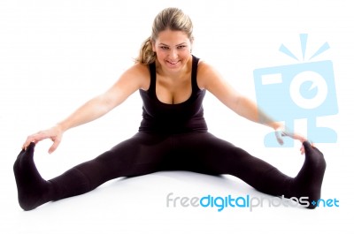 Sitting Female Stretching Her Legs And Arms Stock Photo