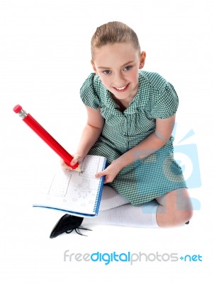 Sitting Schoolgirl Doing Homework Stock Photo