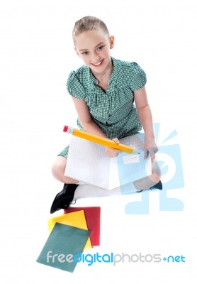 Sitting Schoolgirl Writing In Note Stock Photo