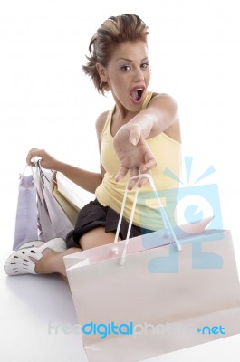 Sitting Sexy Woman Showing Shopping Bag Stock Photo