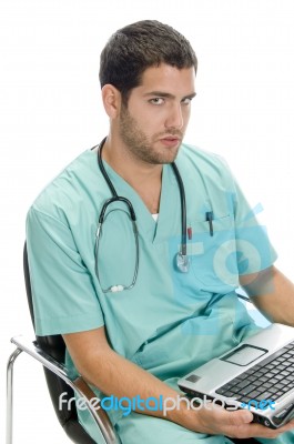 Sitting Surgeon With Laptop Stock Photo