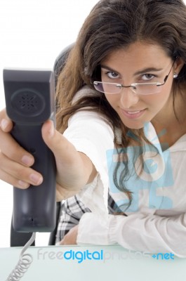 Sitting Woman Showing Receiver Stock Photo