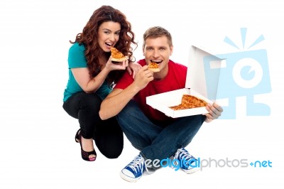 Sitting Young Couple Eating Pizza Stock Photo