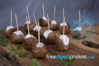 Skewers Of Meat On Wooden Cutting Board Stock Photo