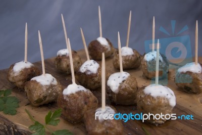 Skewers Of Meat On Wooden Cutting Board Stock Photo