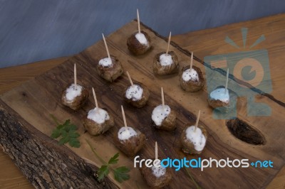 Skewers Of Meat On Wooden Cutting Board Stock Photo