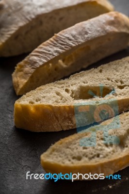 Sliced Ciabatta On The Dark Table Stock Photo