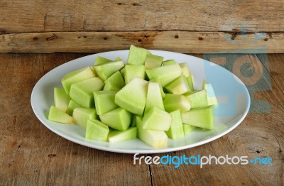 Sliced Melon With Plate On Wooden Background Stock Photo