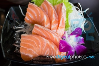 Sliced Salmon Sashimi Served On Black Plate Stock Photo