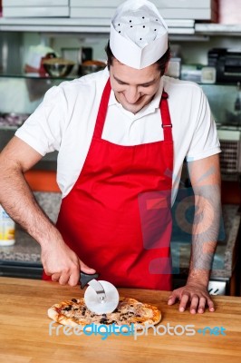 Slicing Pizza Before Delivery Stock Photo