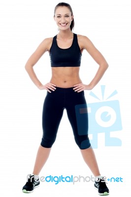 Slim Athletic Woman Posing With A Radiant Smile Stock Photo