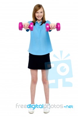 Slim Girl Striking A Pose With Dumbbells. Lifting Weights Stock Photo