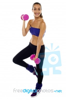 Slim Young Woman Working Out With Dumbbells Stock Photo