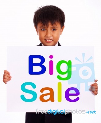 Small Boy Showing Big Sale Board Stock Photo