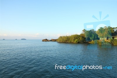 Small Cape And Some House From Tropical Sea Stock Photo