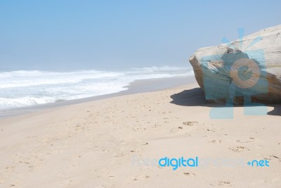 Small Cliff At A Beautiful Beach In Praia Del Rey Stock Photo