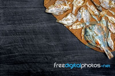 Small Dry Fish From The Sun On The Net Stock Photo