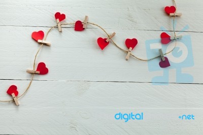 Small Hearts Subjects With Clothespins On White Background Stock Photo