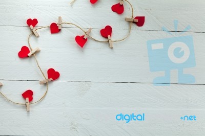 Small Hearts Subjects With Clothespins On White Background Stock Photo