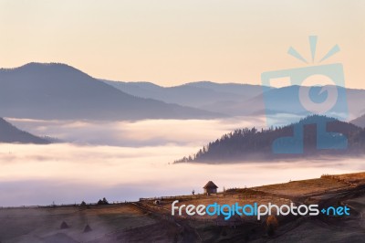 Small Hut On Mountain Pass In Autumn Foggy Morning Stock Photo