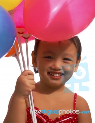 Small Kid Holding Balloons Stock Photo