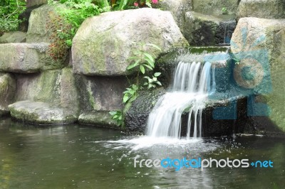 Small Waterfall In Public Tropical Garden Stock Photo