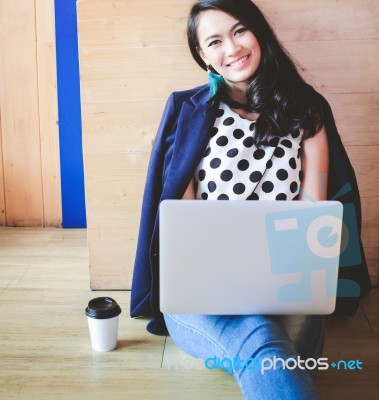 Smart Asian Businesswoman Using A Laptop On The Cafe Floor Stock Photo