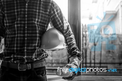 Smart Businessman Holding Construction Helmet And Blueprints In Stock Photo