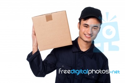 Smart Courier Boy With Parcel On Shoulders Stock Photo