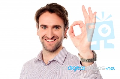 Smart Man Showing Okay Sign Stock Photo