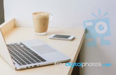 Smart Phone And Laptop With Coffee Cup At Home Or Cafe Stock Photo