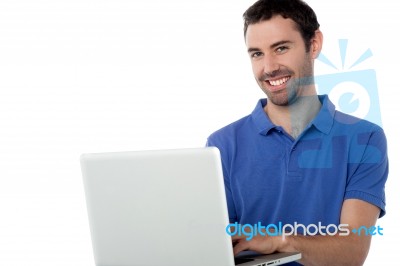 Smart Smiling Guy Working On Laptop Stock Photo