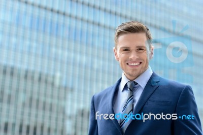 Smart Young Businessman Looking At Camera Stock Photo