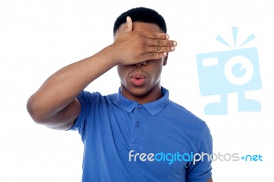 Smart Young Guy Hiding His Eye Stock Photo