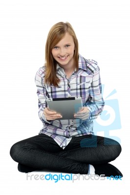 Smartly Dressed Teenager Surfing On Tablet Pc Stock Photo